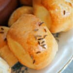 Close-up of some pretzel bites topped with caraway seeds.