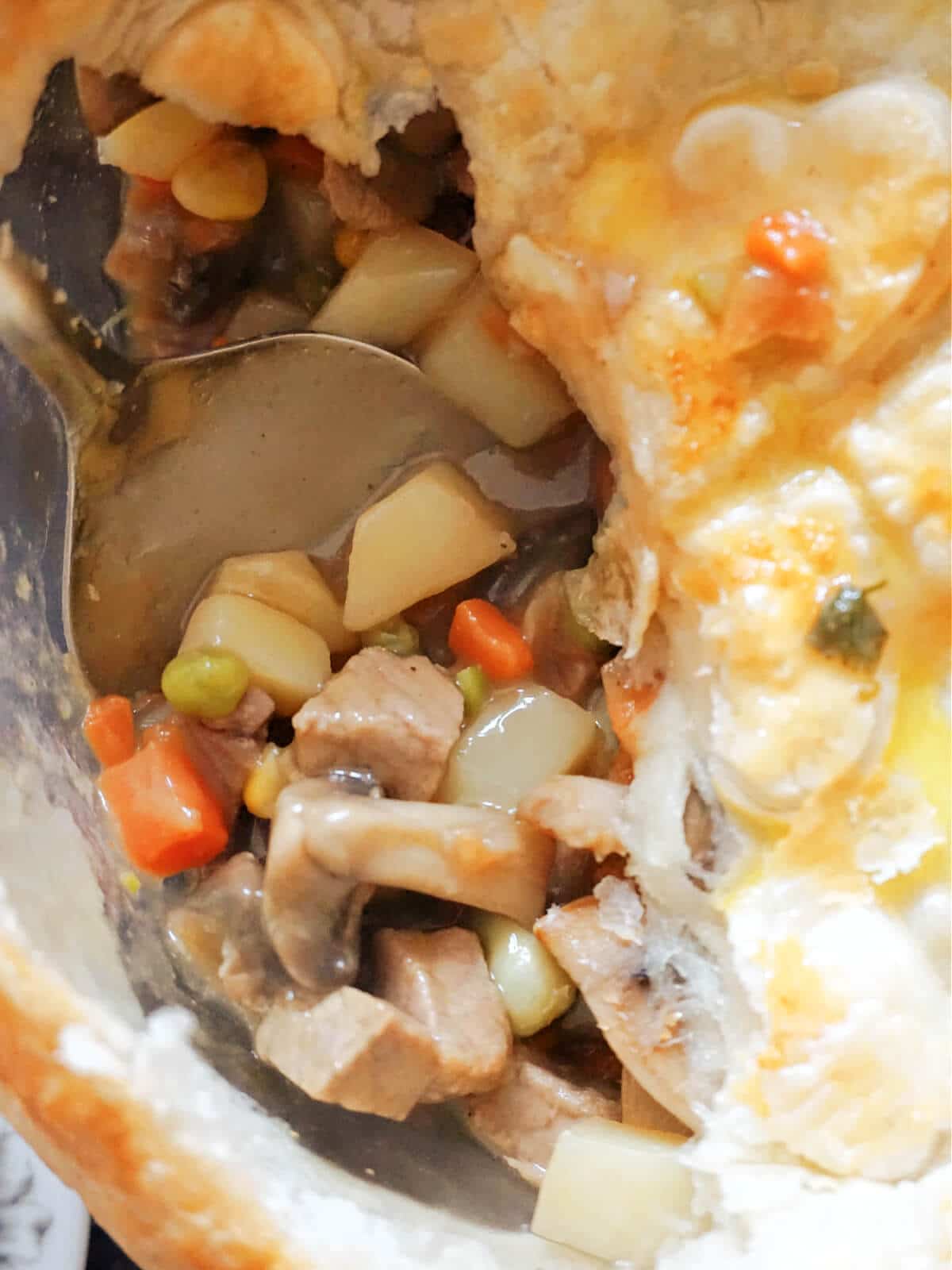 Close-up shot of a beef pie with puff pastry.