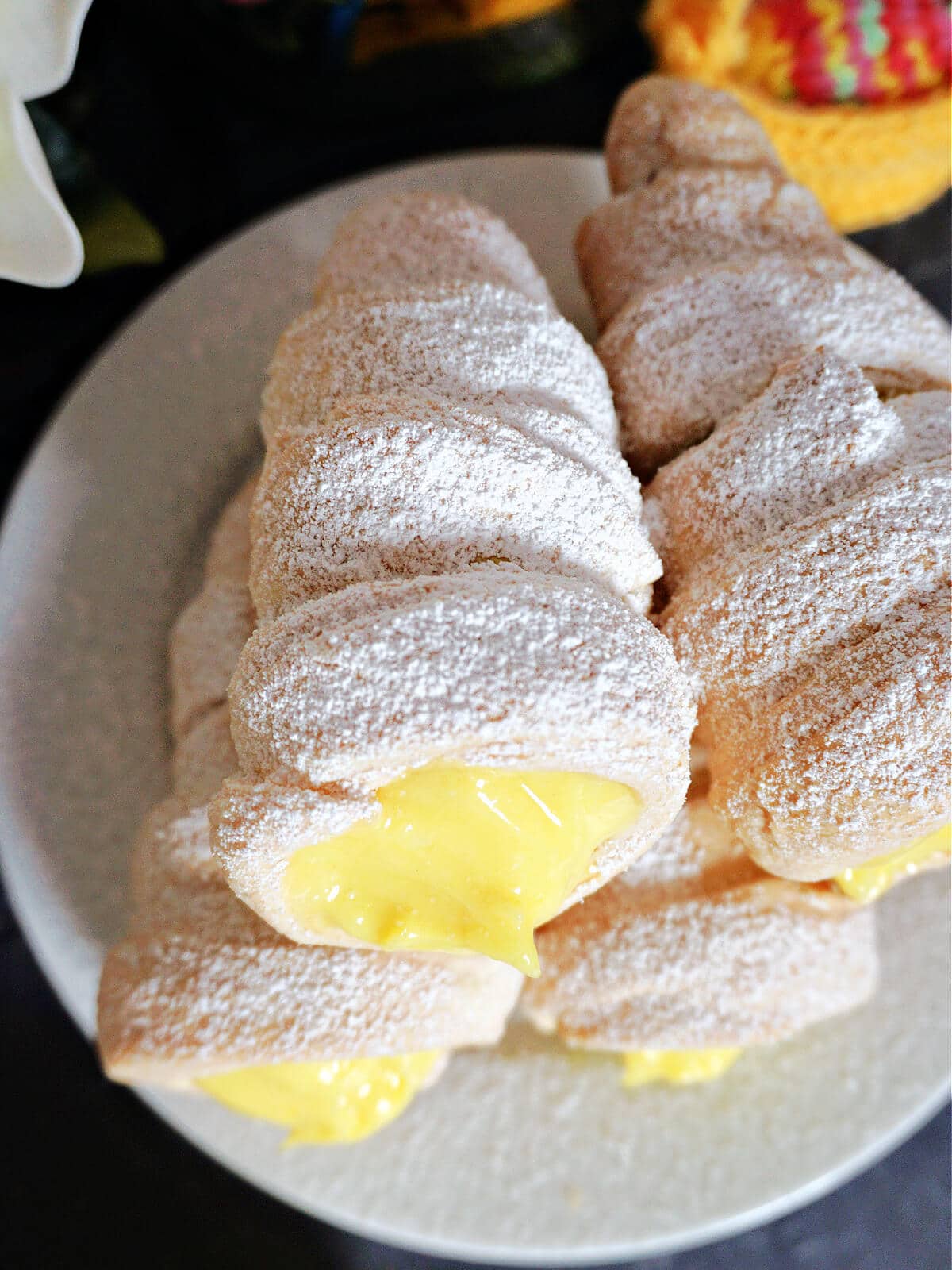 Cream horns on a white plate.