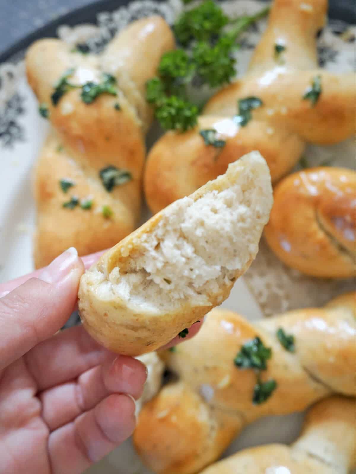 A torn open garlic knot to show how fluffy it is inside