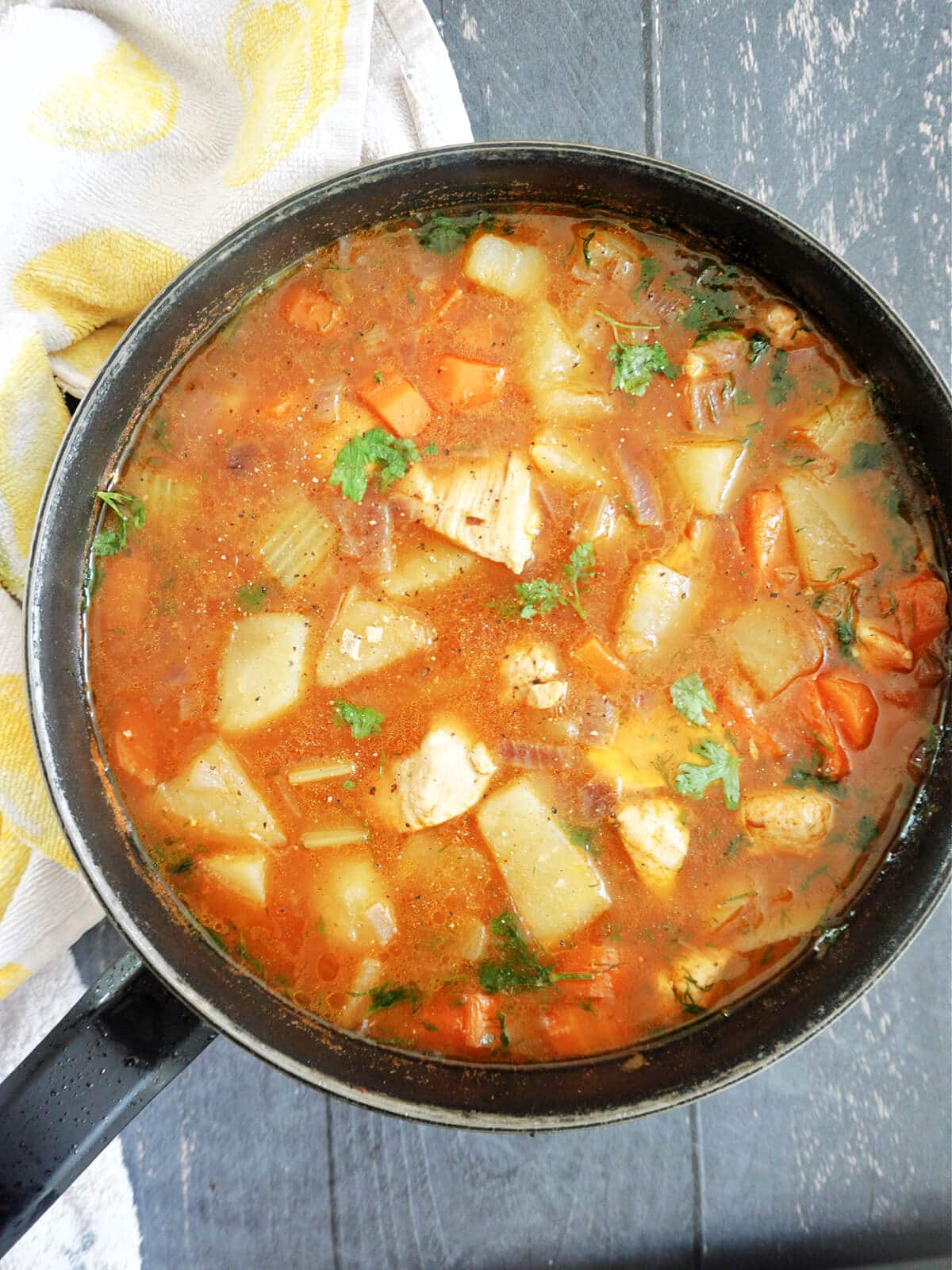 Overhead shot of a pan with chicken and veggie stew.