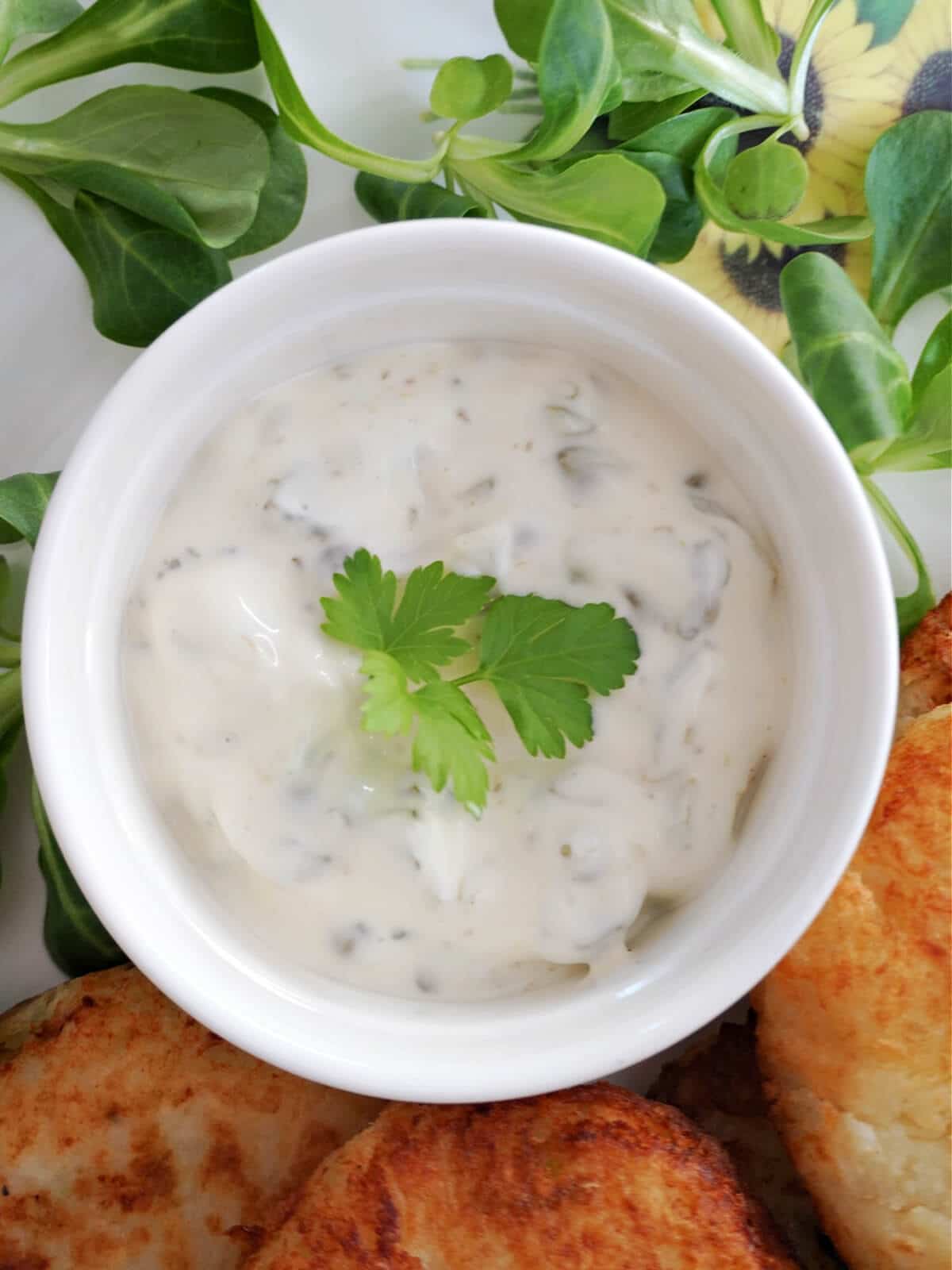 Overhead shot of a ramekin with tartar sauce.