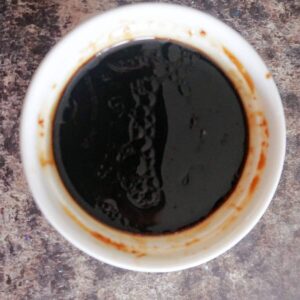 Overhead shot of a white ramekin with stir fry sauce
