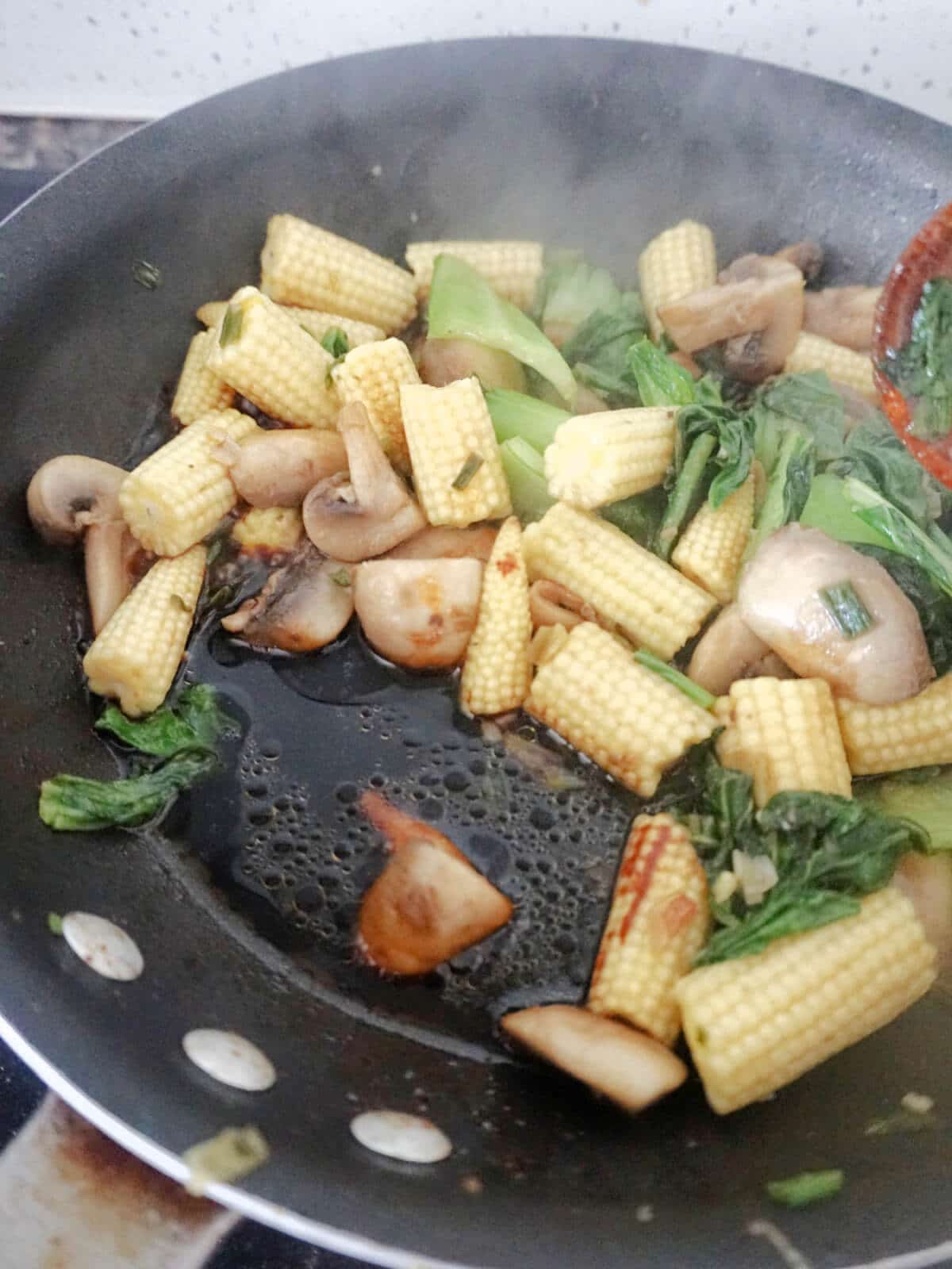 A pan with stir fry and sauce.