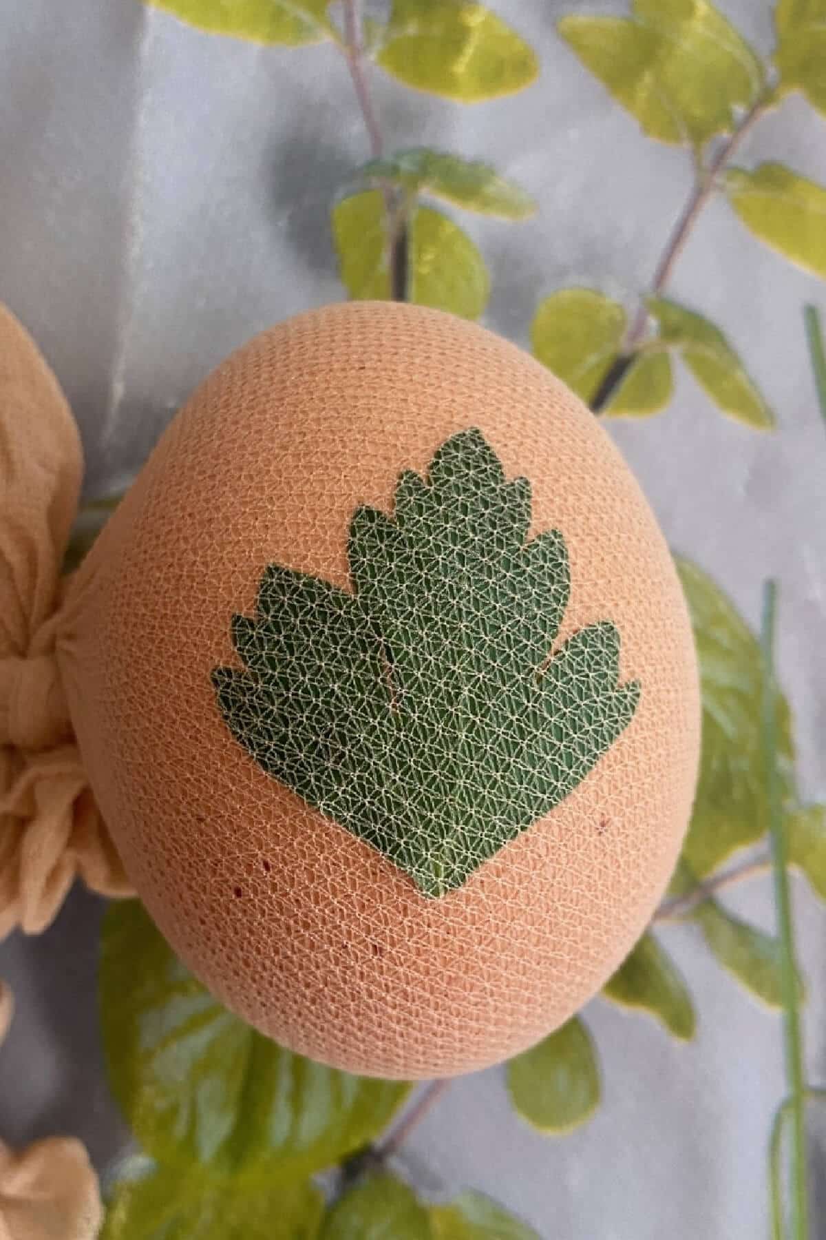 An egg with a parsley leaf on it.
