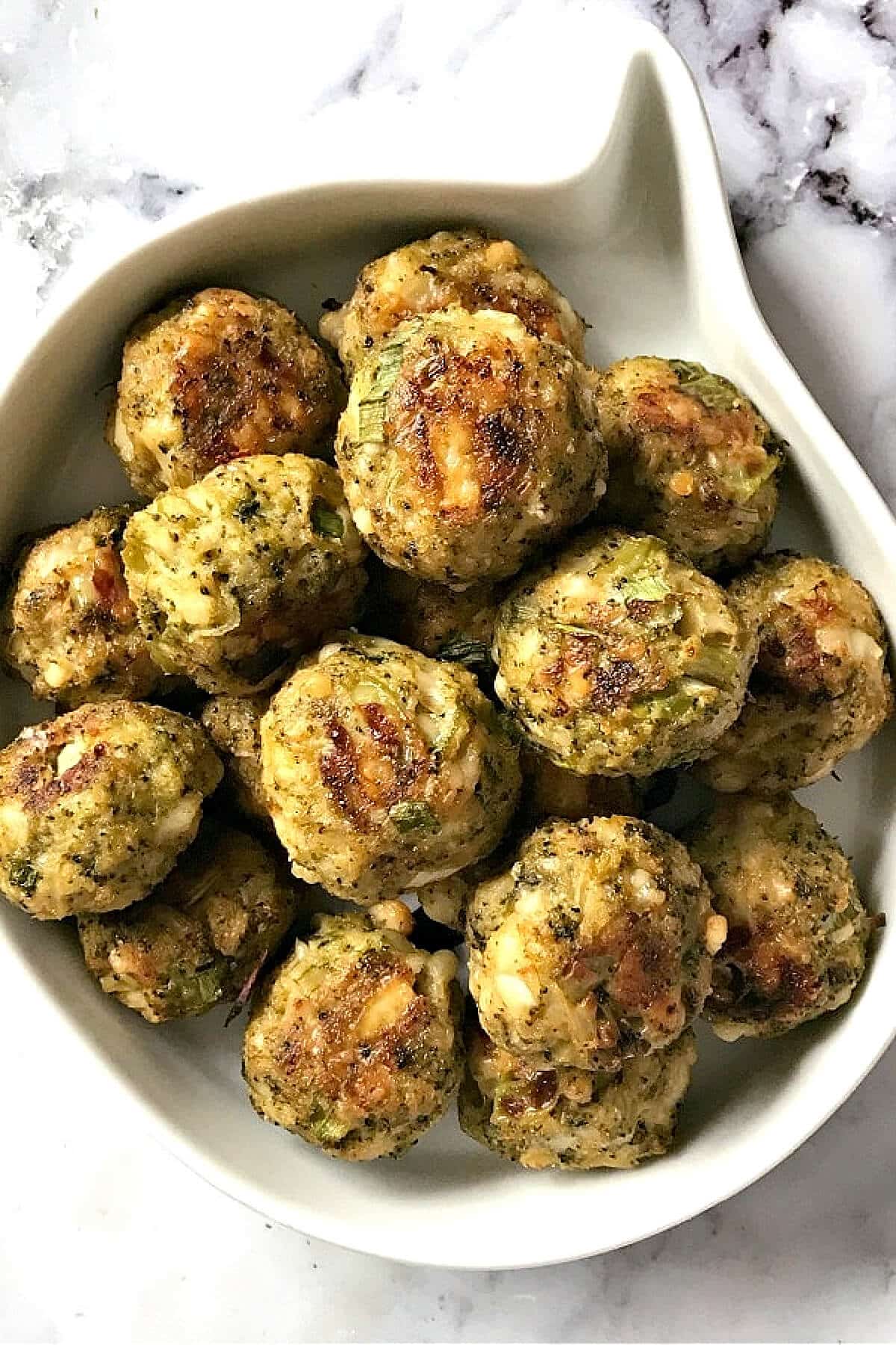 A white bowl with broccoli balls