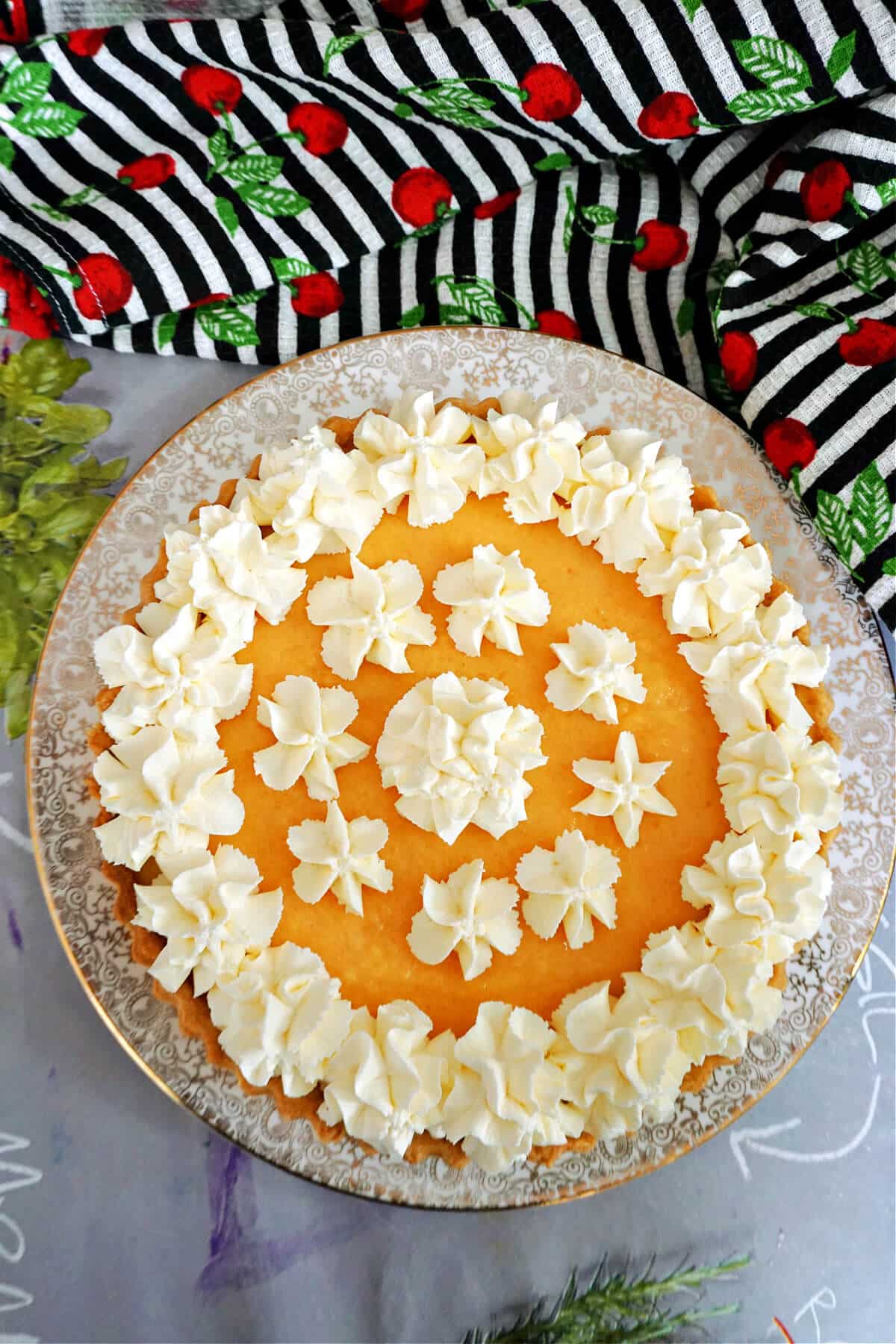 A cantaloupe pie decorated with cream.