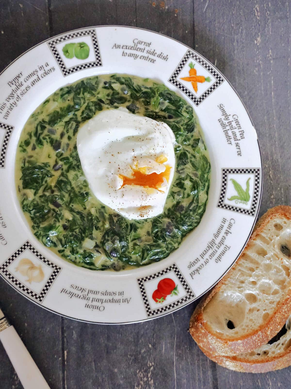Overhead shoot of a white plate with spinach and a poached egg