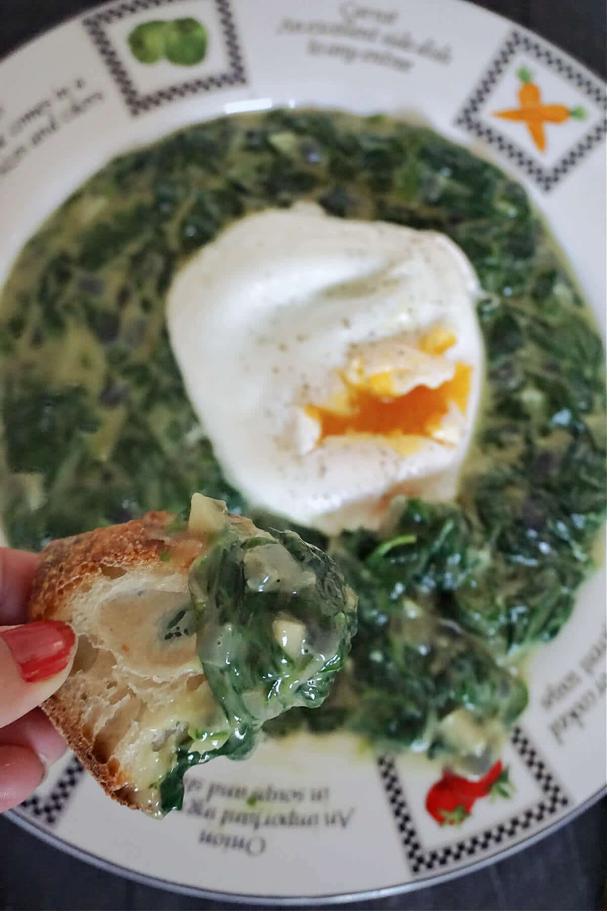 Close-up shot of a plate with spinach dip topped with a poached egg