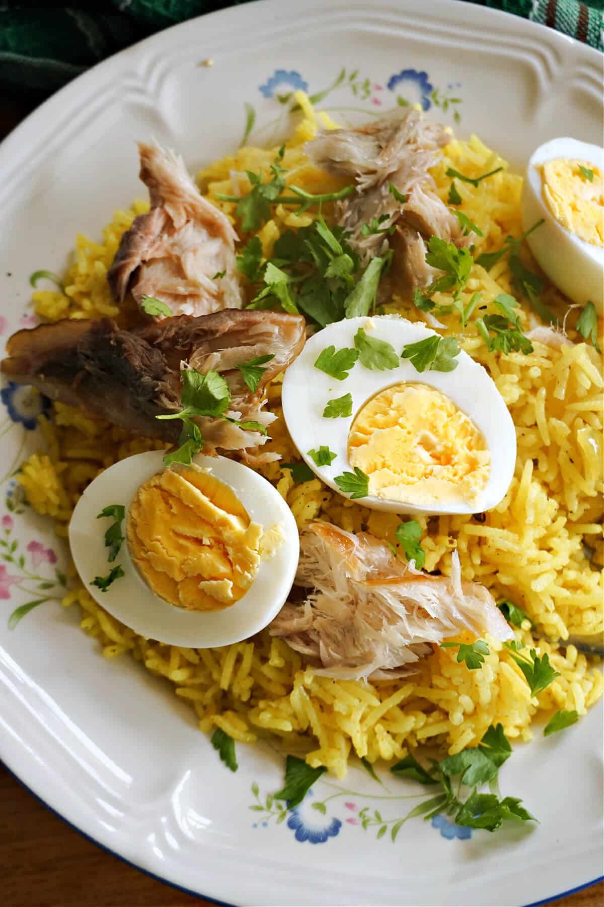 A white plate with smoked mackerel and egg kedgeree.