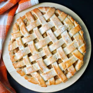 A lattice apple pie on a white plate.