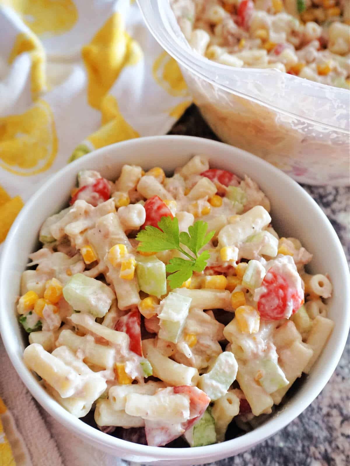 A white bowl of tuna pasta with veggies.