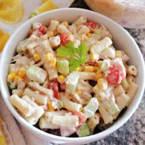 A white bowl with pasta salad with tuna and veggies