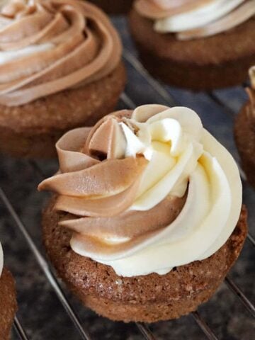 Close-up shot of duo-buttercream cupcakes on a cooling rack