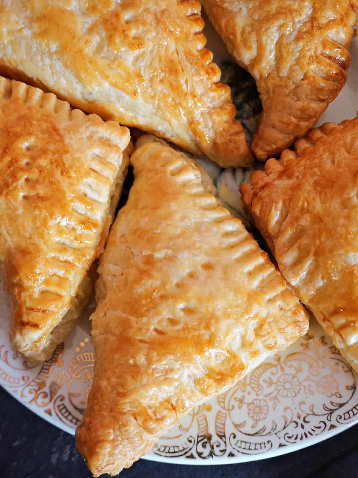 Close-up shot of a pastry triangle with others around it.