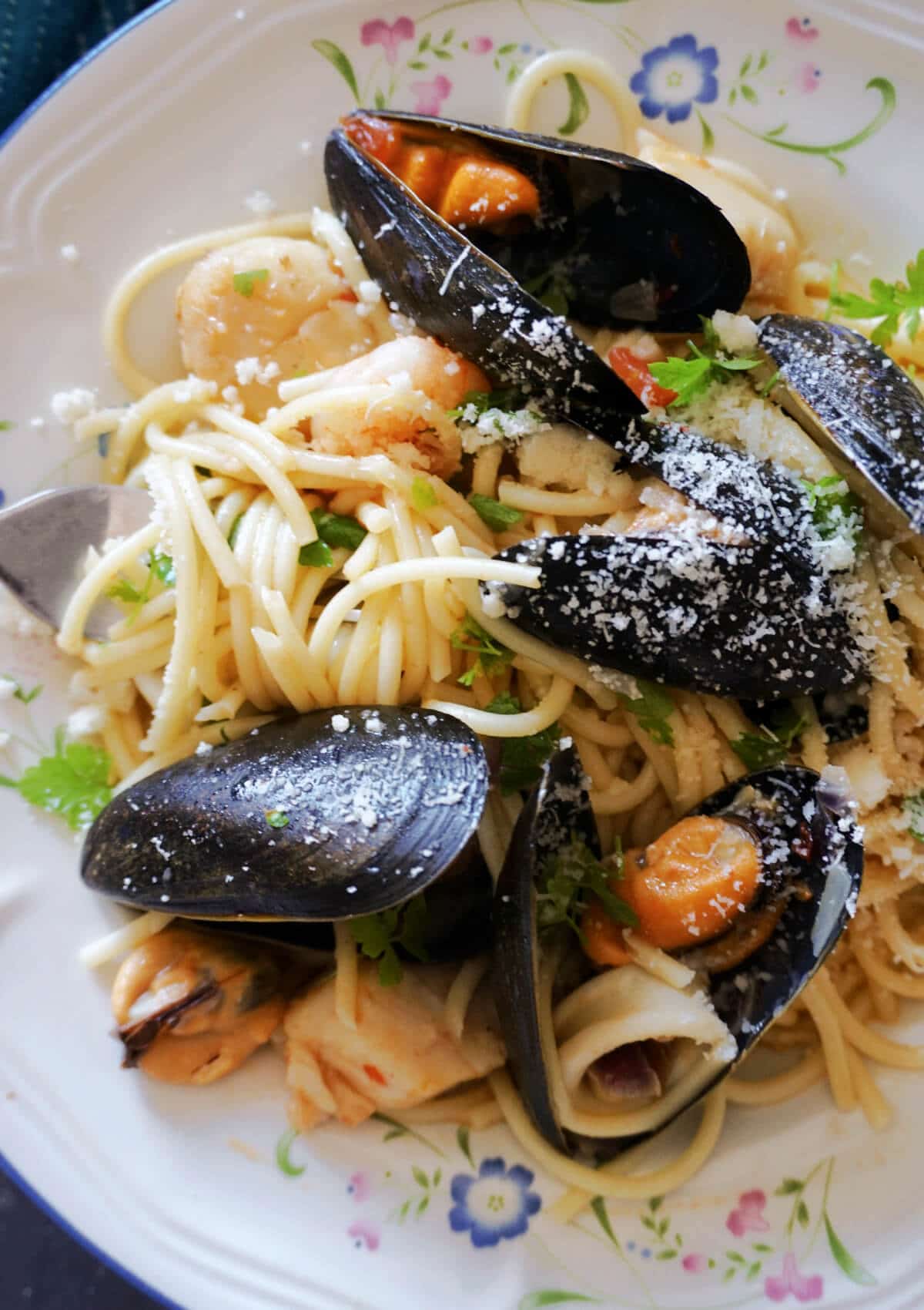 Close-up shot of a plate with spaghetti and seafood.