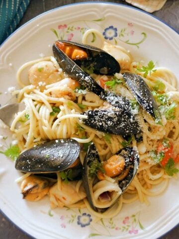 A white plate with seafood spaghetti