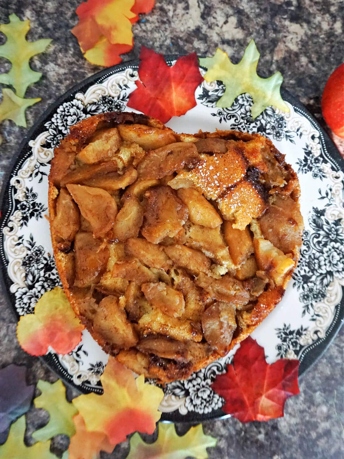 Overhead shot of a plate with a heart-shaped apple upside down cake.