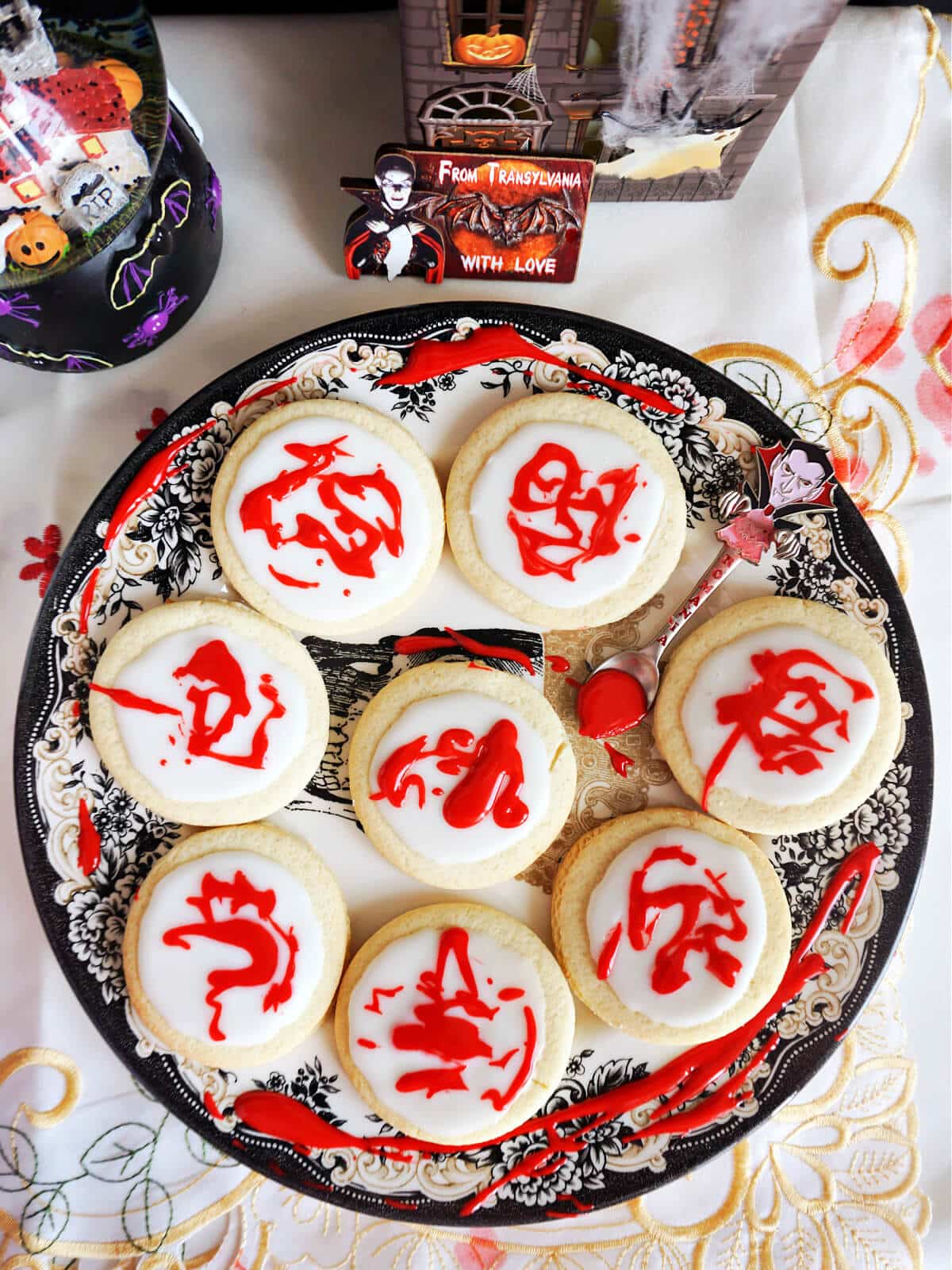 Overhead shoot of a plate with 8 blood splatter cookies.