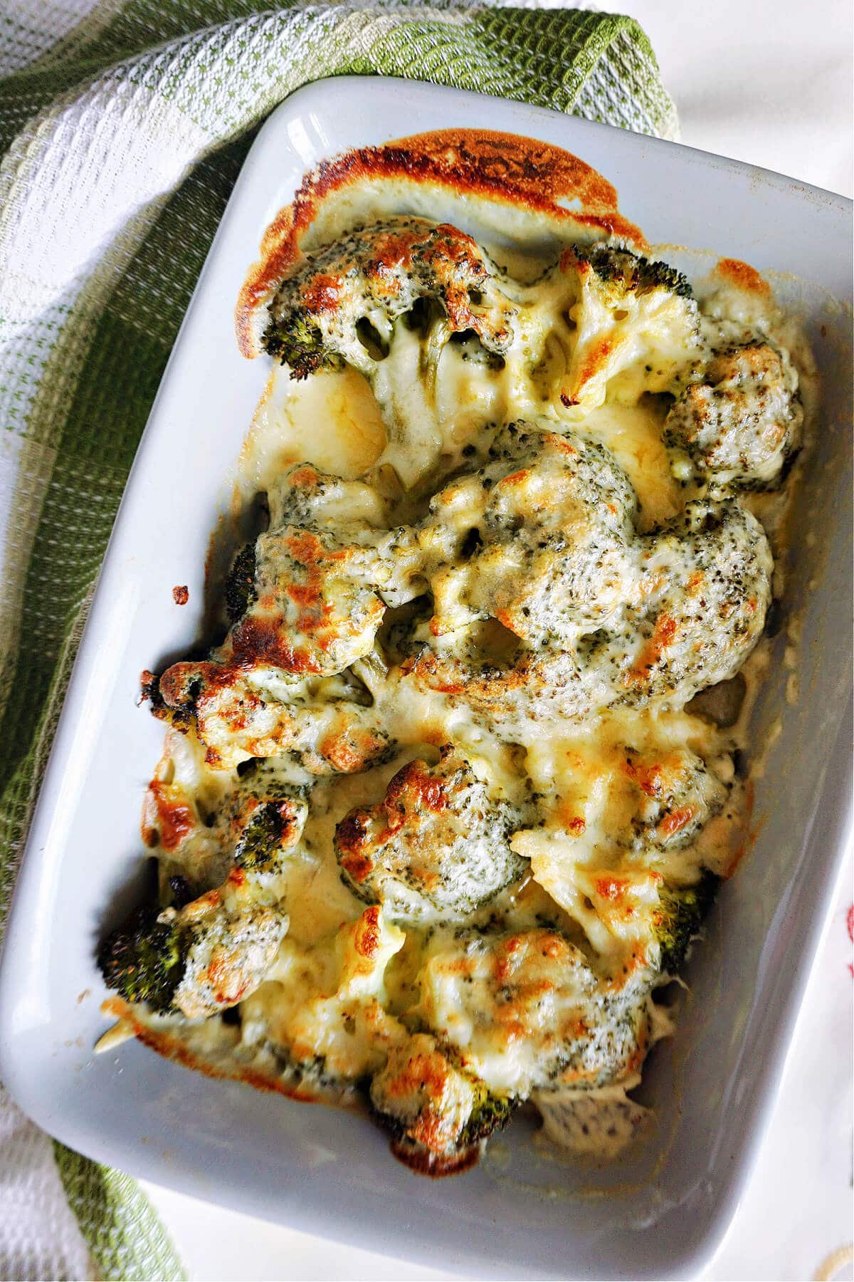 A dish with baked cheesy broccoli.