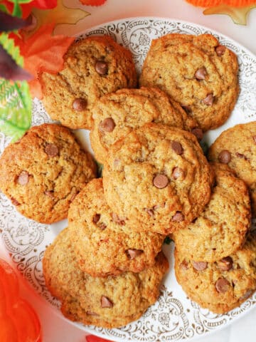 Overhead shoot of a plate with pumpkin cookies with chocolate chips