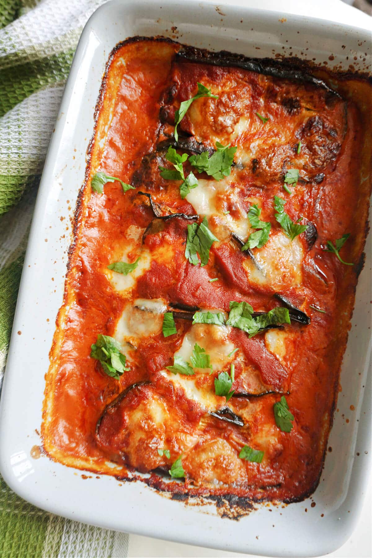 Overhead shoot of a dish with aubergine parmesan.