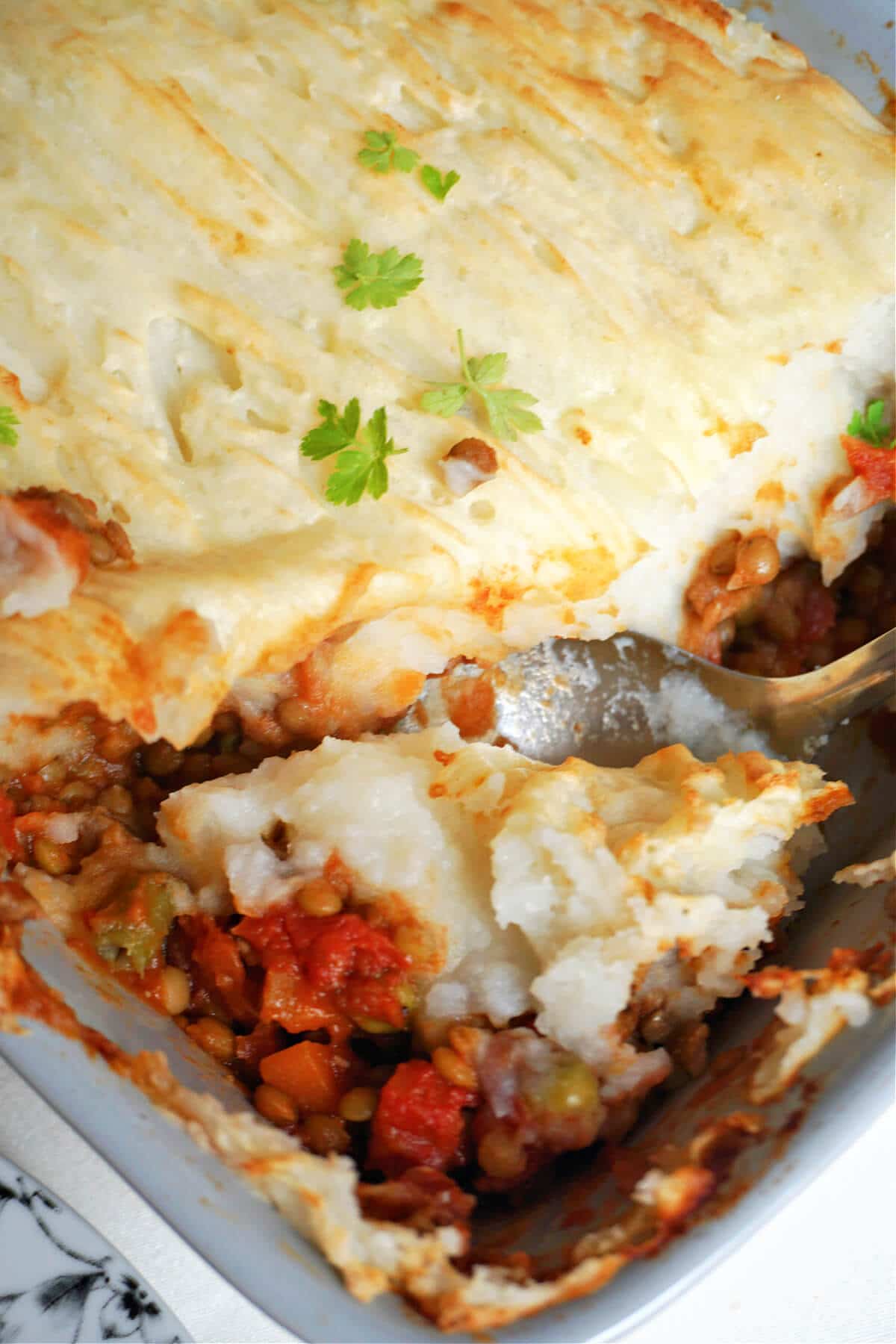 Close-up shoot of a lentil pie in a baking dish.