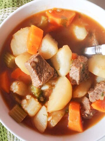 Overhead shoot of a white bowl with beef stew