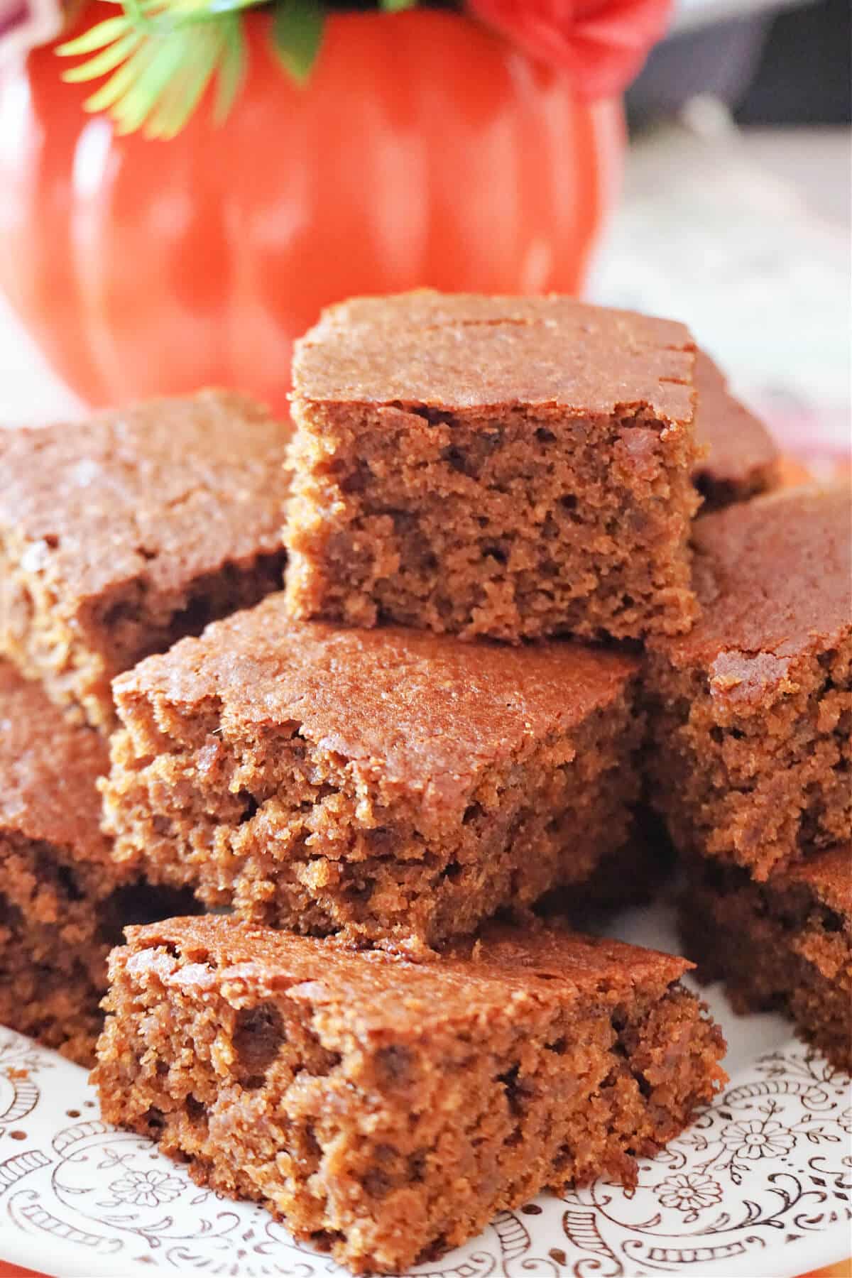 A pile of gingerbread cakes on a white plate