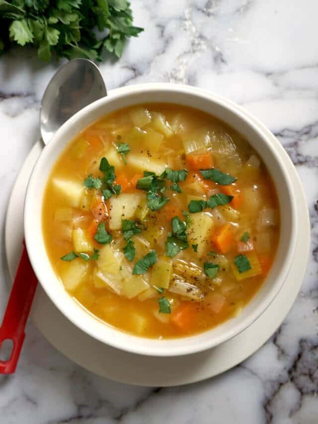 Overhead shoot of a white bowl with leek and potato soup