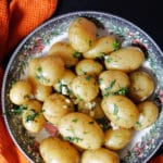 A pan with baby potatoes with herbs and garlic