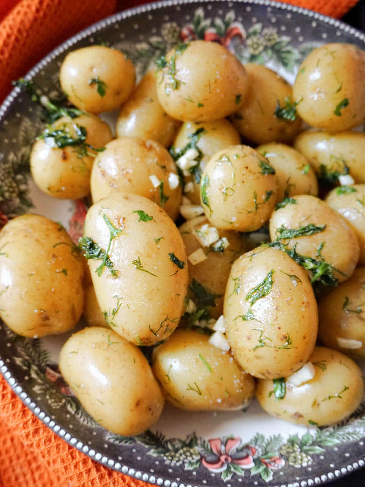 A bowl of garlicy and herby baby potatoes.