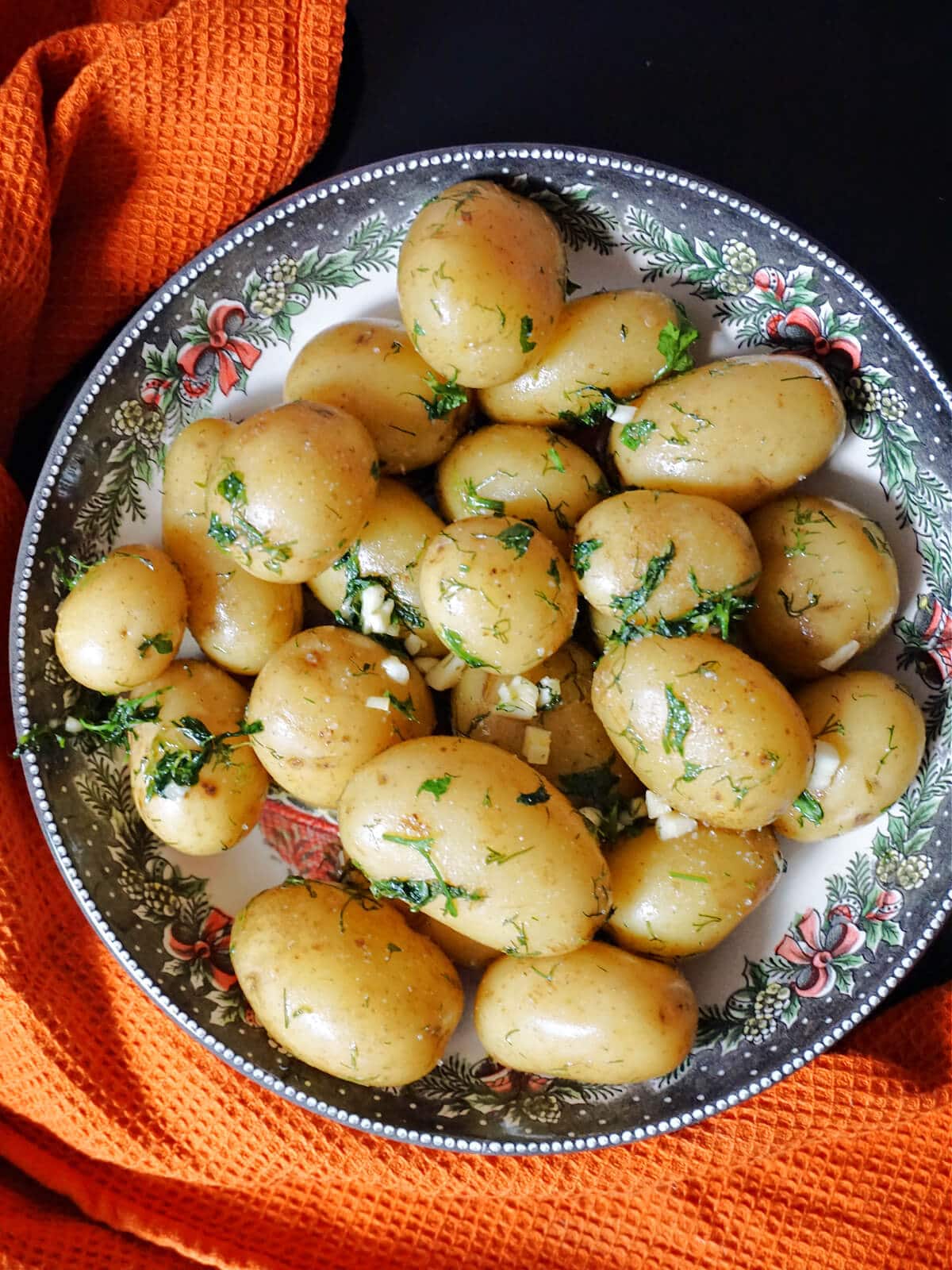 A pan of baby potatoes with herbs and garlic.