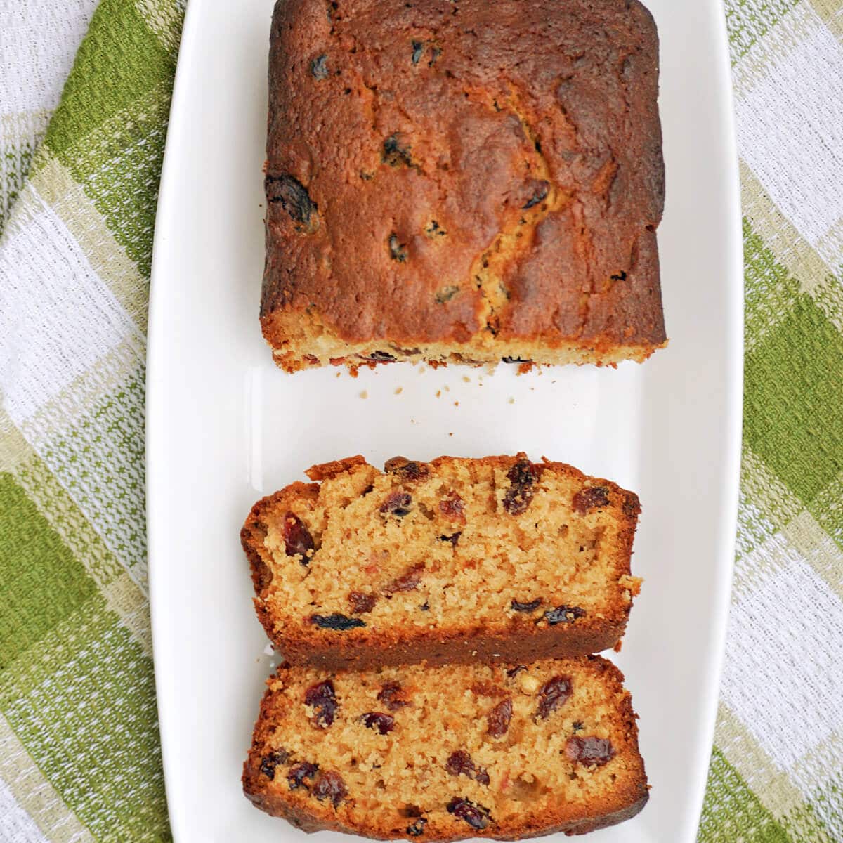 Overhead shoot of a white rectangle plate with a loaf cake.