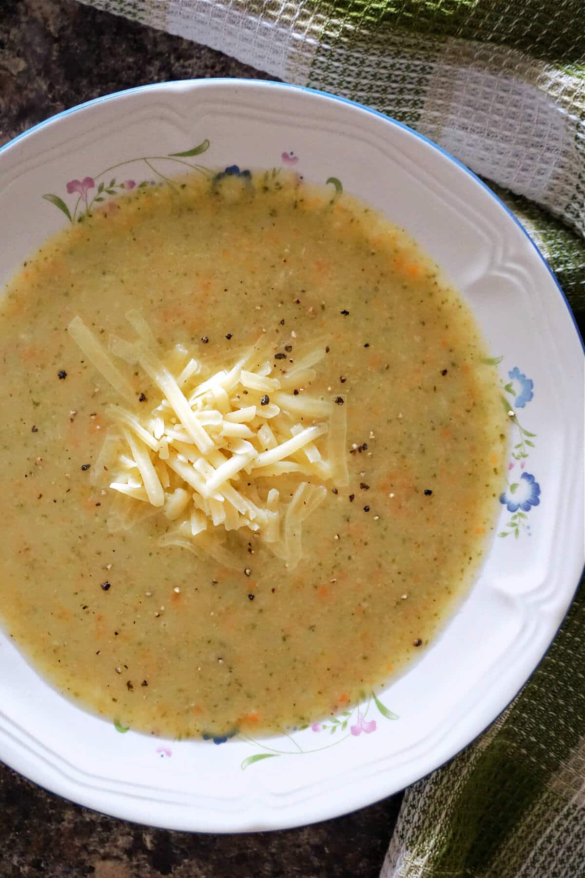 A white bowl with creamy broccoli soup.