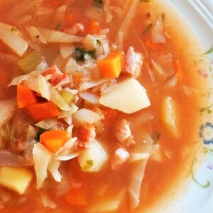 A white bowl of cabbage soup