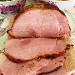 A gammon joint sliced on a wooden board