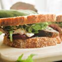 A beef sandwich on a wooden board