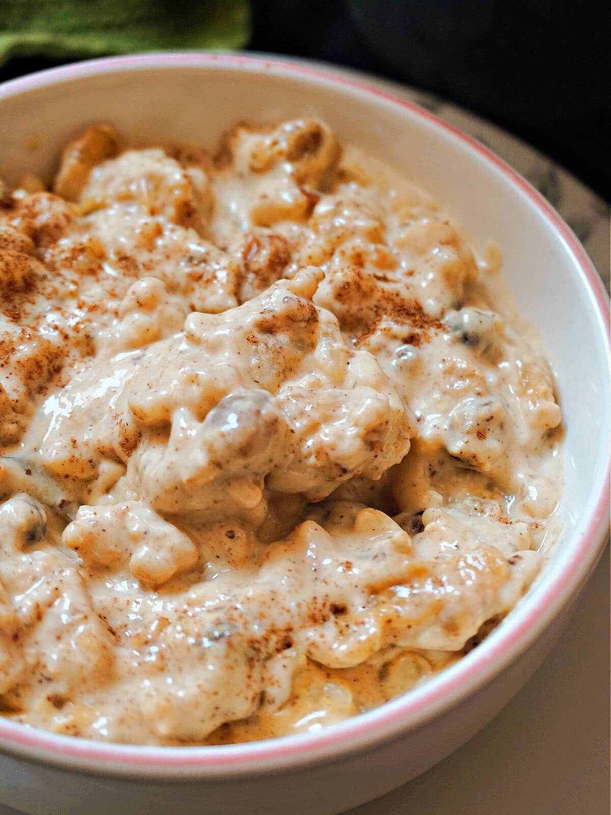 A white bowl with rice pudding.