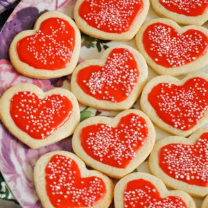 red heart-shaped cookies with sprinkles on top
