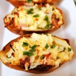 2 loaded potato skins on a white plate