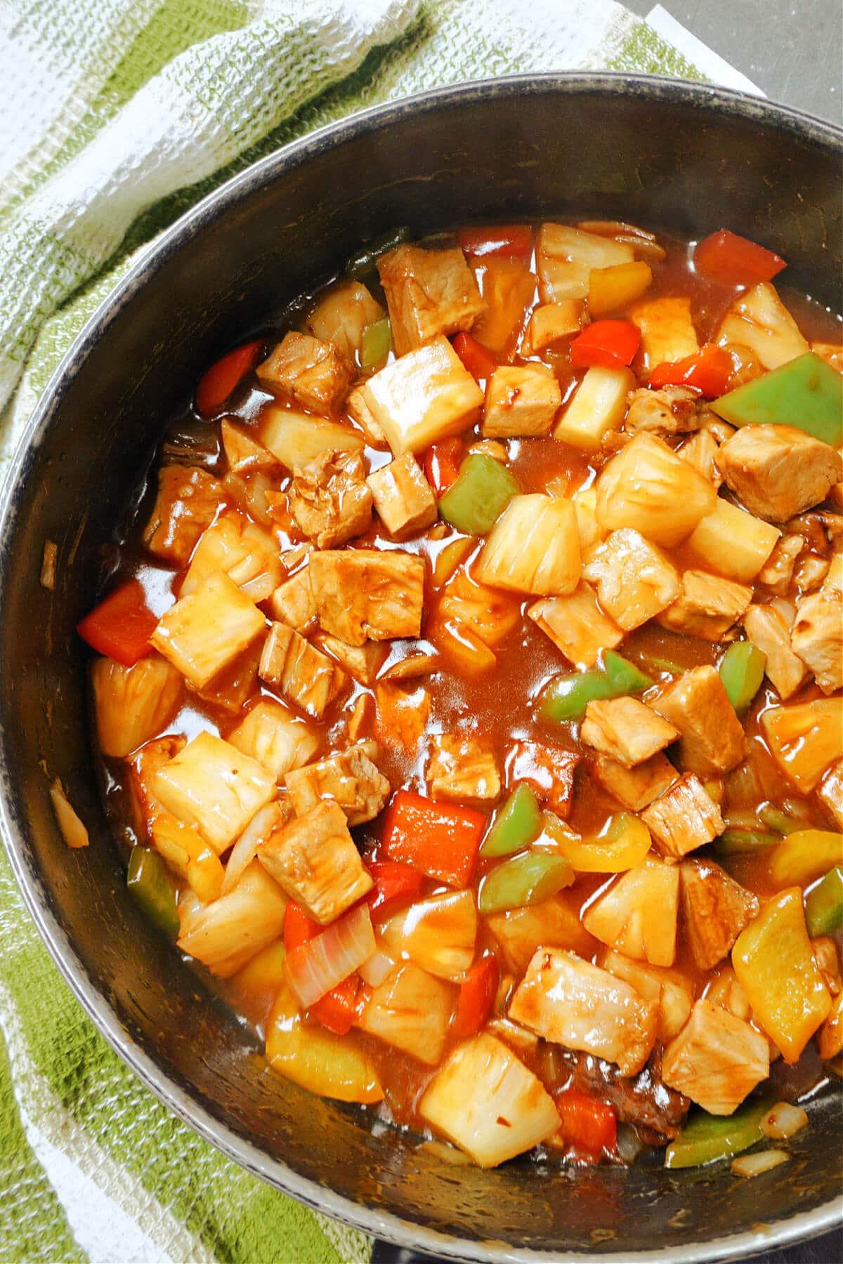 A pan with sweet and sour pork.