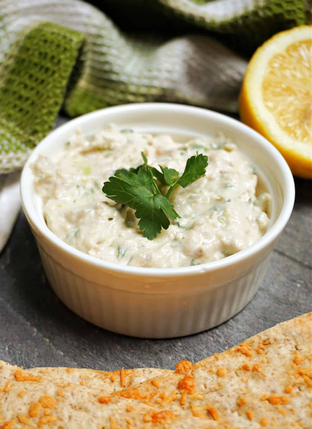 A white ramekin with kipper pate.