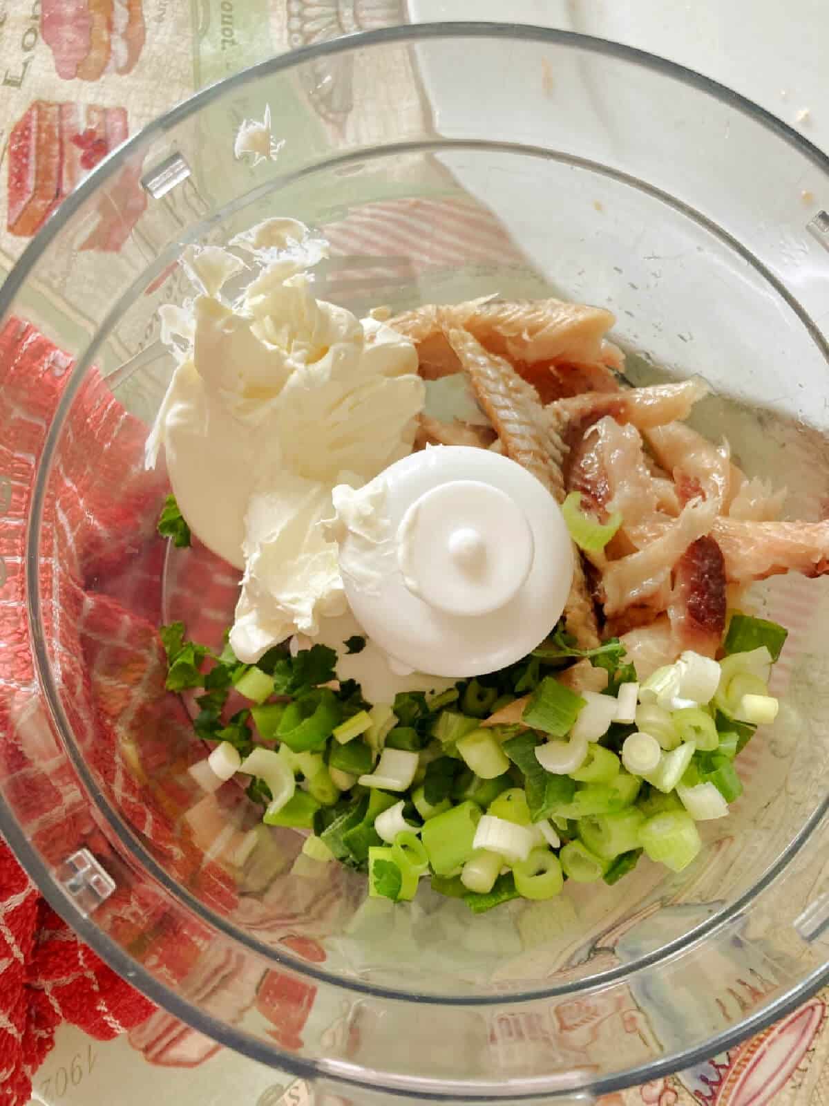 A food processor with ingredients to make kipper pate.