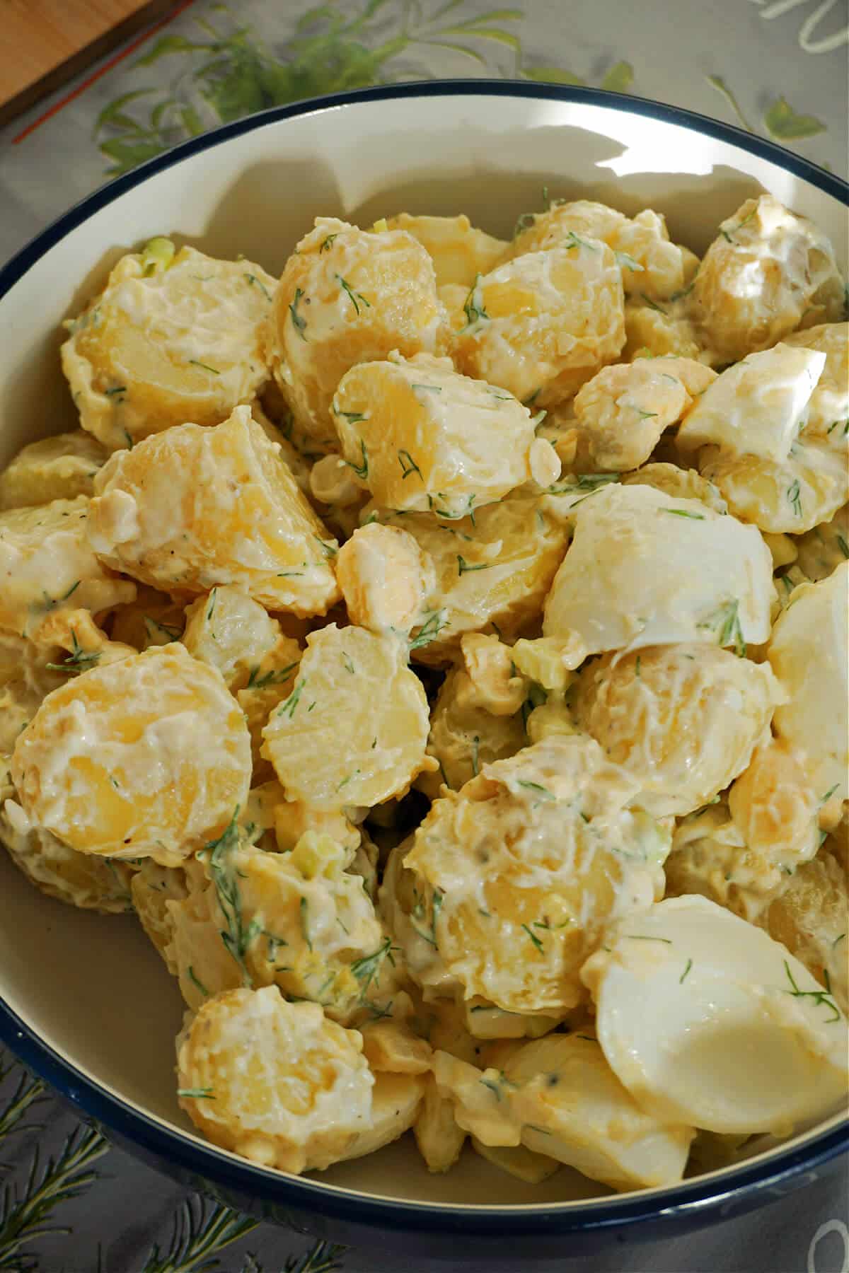 A plate with potato and egg salad.