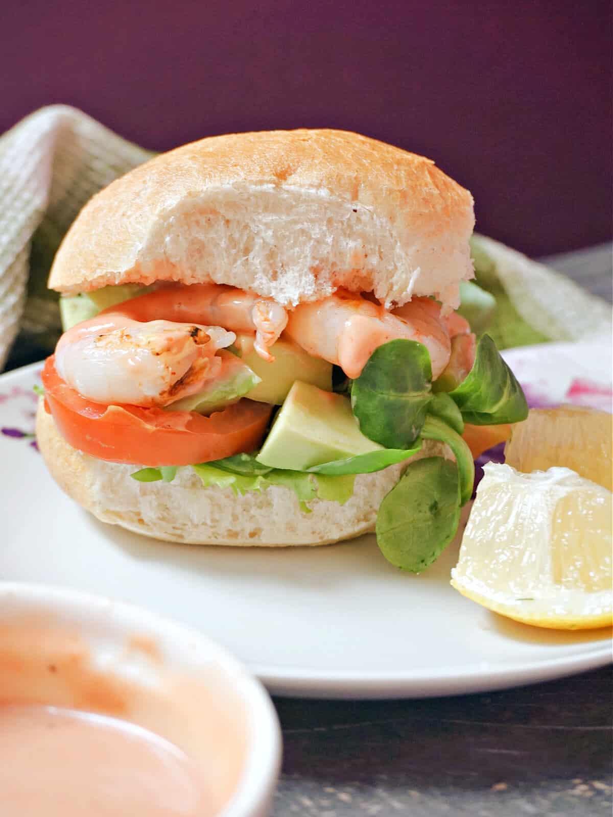 A burger on a white plate.