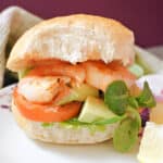 A prawn burger on a white plate