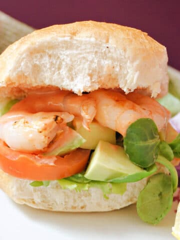 A prawn burger on a white plate