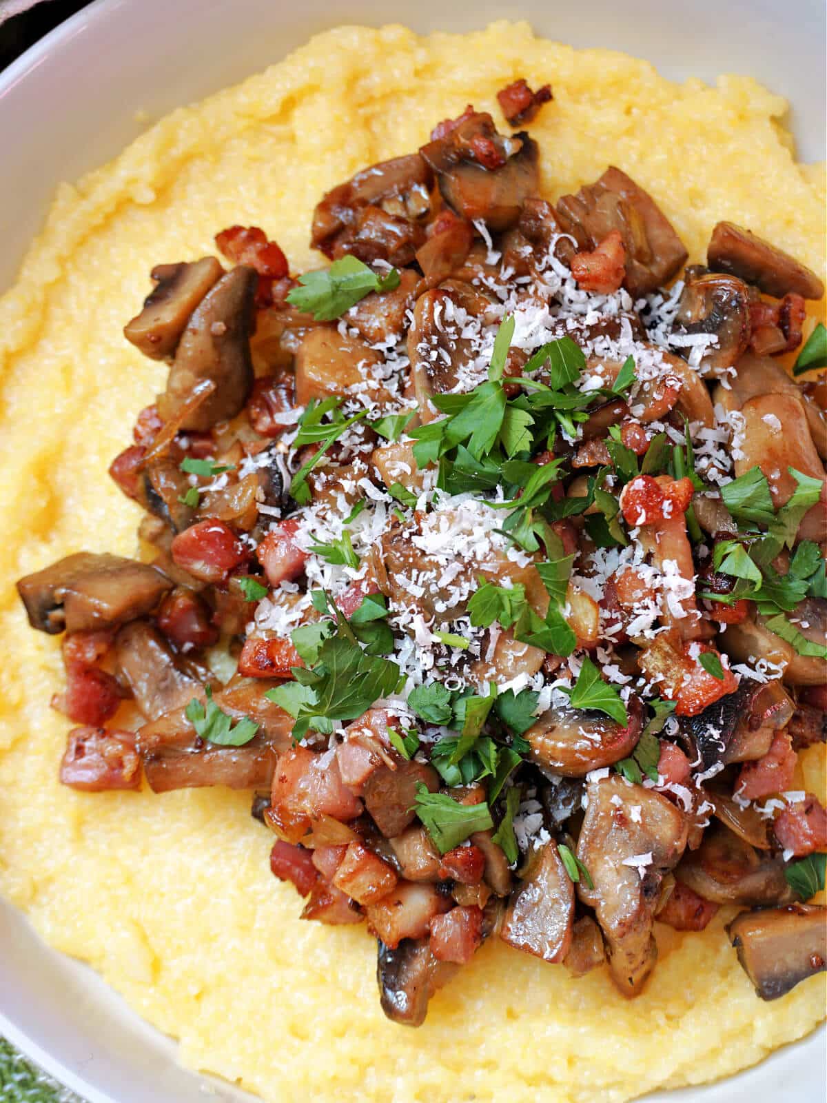 Mushrooms and bacon on a bed of polenta.