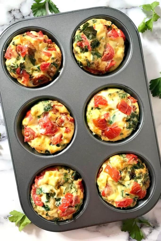Overhead shoot of a 6-hole muffin tin with egg muffins